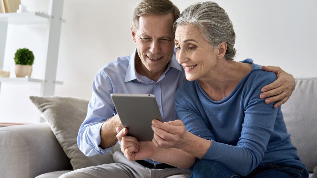 happy-professional-senior-couple-tablet Annual Enrollment Period research