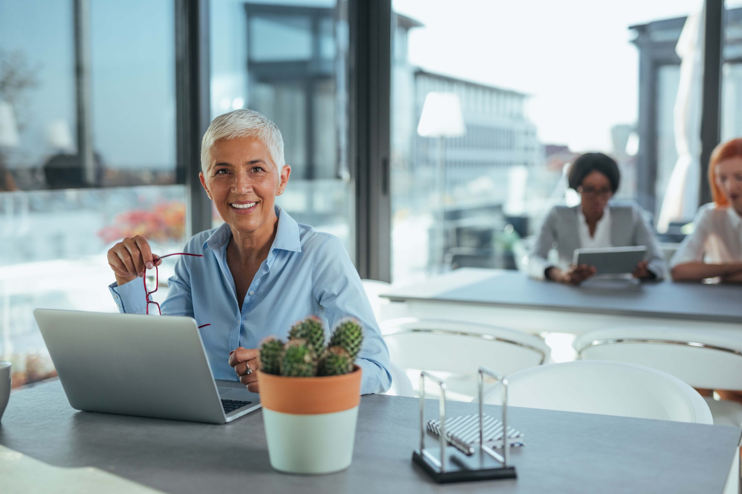 woman in office in front of computer researching medicare