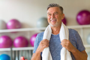 healthy man smiling in gym after senior fitness test