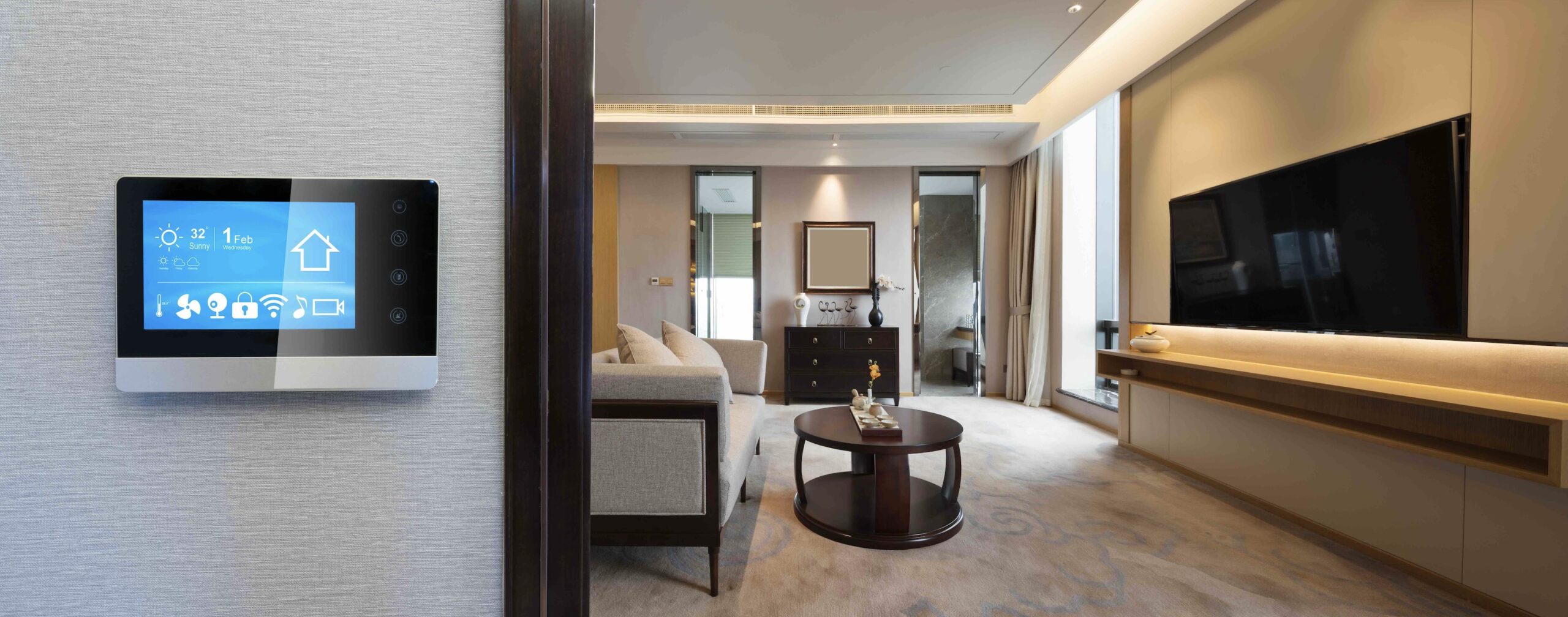 Image of a living room with a touch screen panel outside. Thermostats and lighting are just two examples of the best smart home devices for older adults to improve their day-to-day.