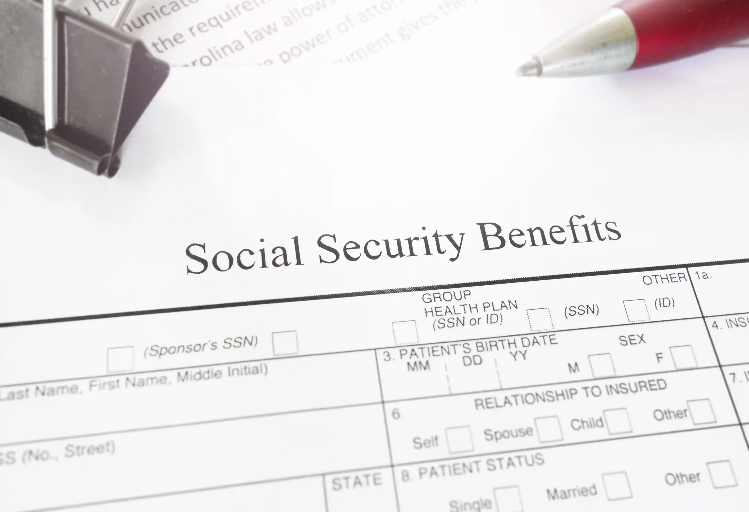 A close-up of a Social Security Benefits application form with the key question of when to start social security as the central topic.